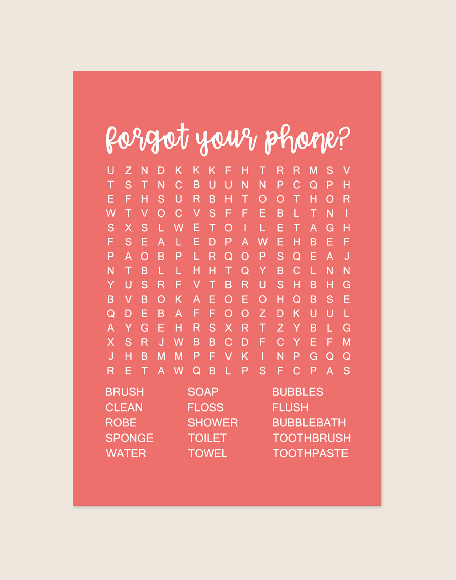 Vrolijke koraalrode poster met een witte woordzoeker en de tekst forgot your phone?, sfeervol opgehangen aan een neutrale muur in een moderne toiletruimte.