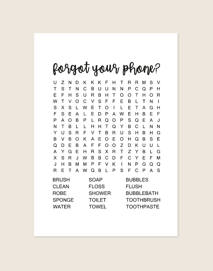 Minimalistische zwart-witte poster met een zwarte woordzoeker en de tekst forgot your phone?, sfeervol opgehangen aan een neutrale muur in een moderne toiletruimte.